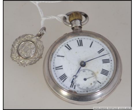 A  silver early 20th century crown wind pocket watch with enamel face having faceted hands and subsiduary seconds dial. Toget