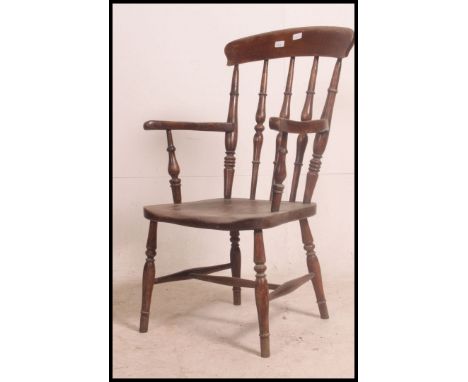 A Victorian beech and elm Windsor chair having turned legs with saddle seat beneath bobbin turned back rests and shaped elbow