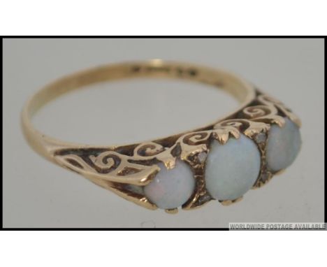 A 9ct gold vintage opal ladies 3 stone ring on gypsy setting. Hallmarked for London 1973. Size Q.5 / Weight 3.0g