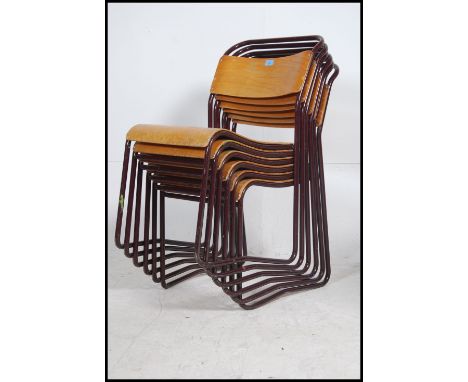 A set of six vintage mid 20th century church / village hall stacking chairs. With Burgundy tubular frames having panel seats 