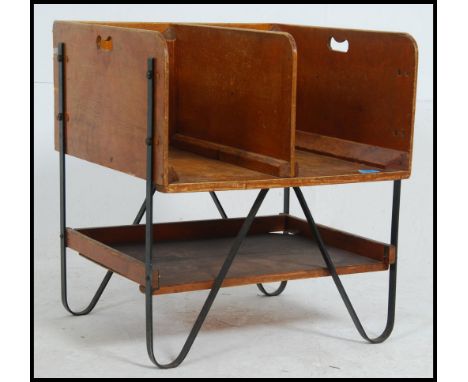 A vintage industrial Post Office sorting unit with two upper compartments with cut out carry handles above a lower tier. Rais