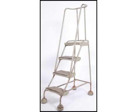 A stunning retro / vintage industrial mid 20th century metal tubular Library / factory ladder. Having four steps with rails t