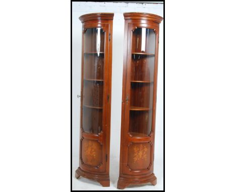 A pair of antique style walnut marquetry inlaid bow front corner cabinets of good column shape and form. Measures: 200cms hig