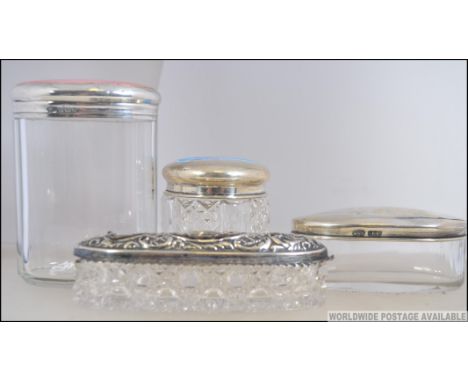 A silver hallmarked rouge pot - dressing table pot together with others to include an enamel top large silver example, rococo