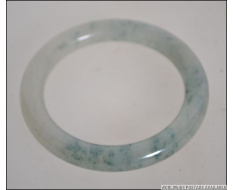 A 20th century green and mutton coloured jade bangle of roundel form. Total weight 59.6g. 