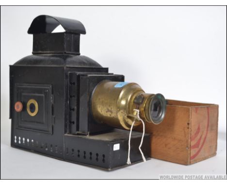A 19th century magic lantern of metal and brass form together with a large collection of slides to include eclesiastical, arc