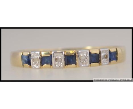 A 9ct / 375 marked ladies sapphire and diamond ring. Pave set cushion cut sapphires with diamonds approx 4-6pnts. Total weigh