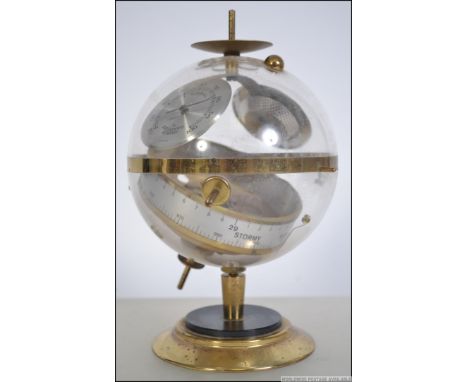 An original retro 1960's German Novelty Sputnik Weather Station barometer. The brass terraced base having glass globe with in