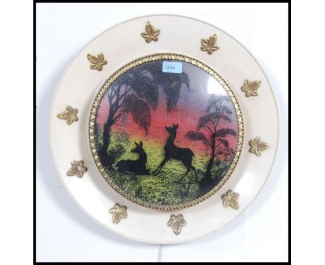 A 1950's retro Danish influenced wall lamp light having diorama of stag with northern lights to the background having lattice