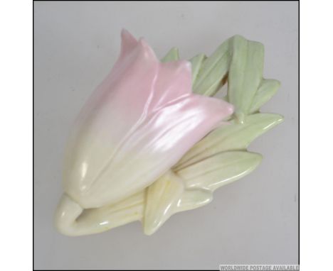 A Royal Worcester wall pocket in the form of a flower having vine and leaf back with green Worcester back stamp. Measures 6cm