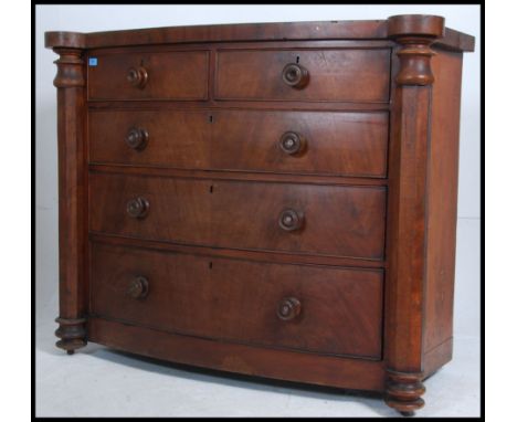 A Victorian Scottish bow front mahogany chest of drawers having knob handles with 2 short over 3 deep configuration. Column s