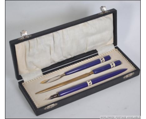 A vintage 20th century cased ceramic handled desk set consisting of Ink pen, paper knife etc