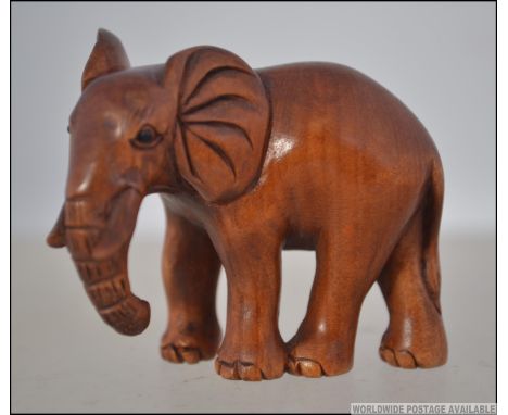 A Japanese carved figure - netsuke type of an elephant bearing a signature to the base