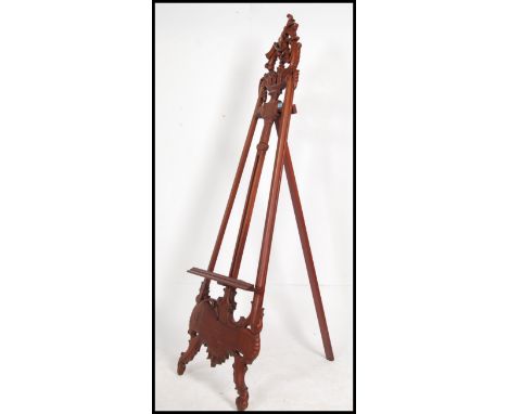 A 20th century Hardwood full height easel - artists stand with rococo form together with a framed and glazed print. Measures:
