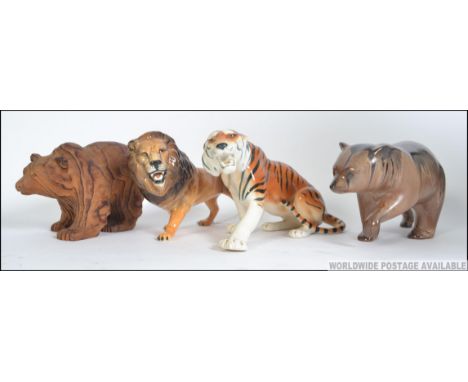 A collection of ceramics to include a Beswick prowling Lion, a USSR Tiger, ceramic bear along with Black Forrest style Canadi