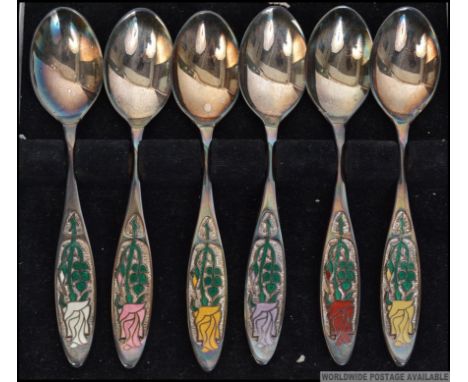 A cased set of  6 silver & enamel hallmarked spoons complete in the presentation box. The handles marked to verso for the Yea