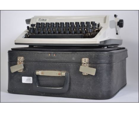 A vintage mid century portable Erica typewriter, cased within it's original black carry case with handle to front W36cm