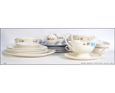 A Wedgwood Moss Rose No T432 pattern part dinner service to include gravy boat, tureen, dinner plates etc. All stamped to the