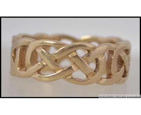 A 9ct hallmarked gold celtic knot twist band ring of good size and weight. Birmingham hallmarks, makers SLD. Size S.5 / Weigh