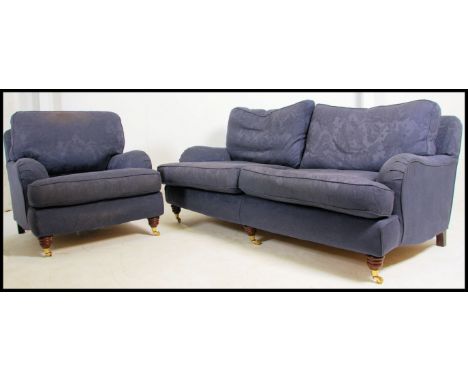 A contemporary Howard style 3 seat Chesterfield sofa settee by Multiyork. Turned legs with brass castors having a Howard shap