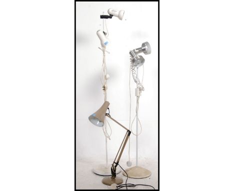 A near pair of retro 20th century adjustable floor standing lamps along with a Herbert Terry Anglepoise desk lamp on circular