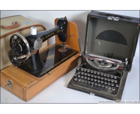 A vintage cased early 20th century Imperial portable reporters typewriter together with a 1950's cased Singer sewing machine.