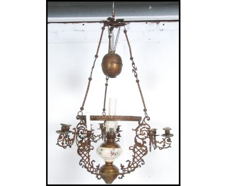 An Austrian early 19th century continental rise and fall oil lamp complete with ceramic reservoir and glass flue having milk 