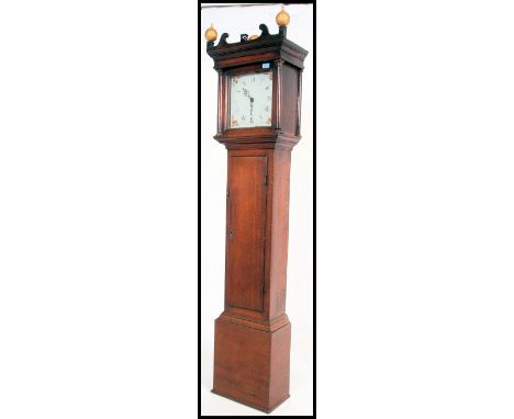 A Georgian 19th century country  oak longcase clock. The painted face with inset movement complete with weight and pendulum. 