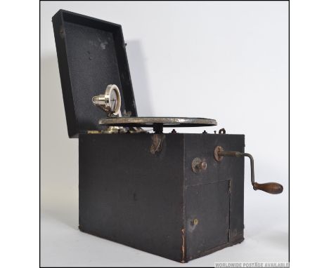 An early 20th century portable cased Concert Gramophone. The vinyl case having a hinged top containing all the components for