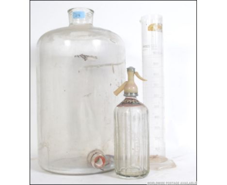 A vintage mid 20th century Pyrex flagon / Demi - John along with a vintage Pyrex scientific measure with measures to the oute