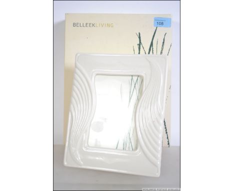 A contemporary Belleek ' Living ' ceramic picture frame complete in the original packaging, Frame measures 154mm x 102mm