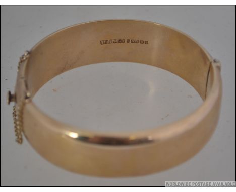 A large 9ct gold / 375 hallmarked ladies bangle complete with the safety clasp. Stamped for Birmingham 1991, makers S.P.S.& C