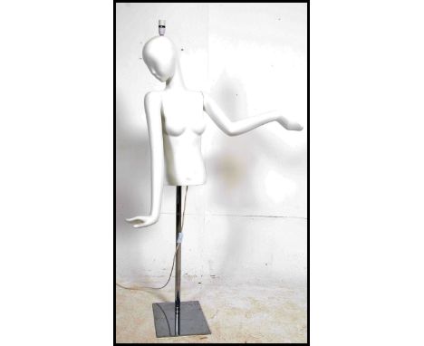 A vintage 20th century female shop display mannequin being raised on an adjustable chrome base. Being fitted with an unusual 