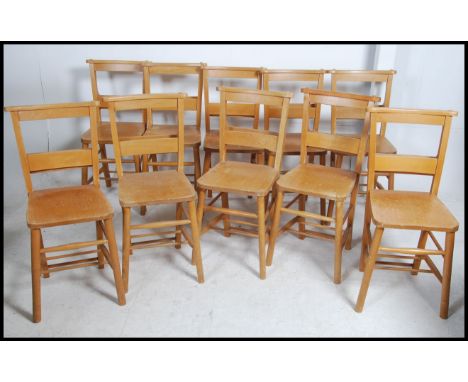 A Set of ten mid 20th century beech wood chapel chairs each with a fitted rear book trough. Measures 83cm high x 40cm wide x 