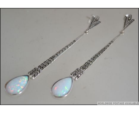 A pair of ladies silver marcasite and opal set Art Deco style drop earrings. Measures 6cms long / Weight 8.2g