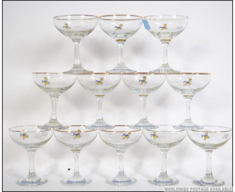 A collection of twelve vintage / retro collection of Babycham advertising glasses, each glass having a yellow Fawn and Babych