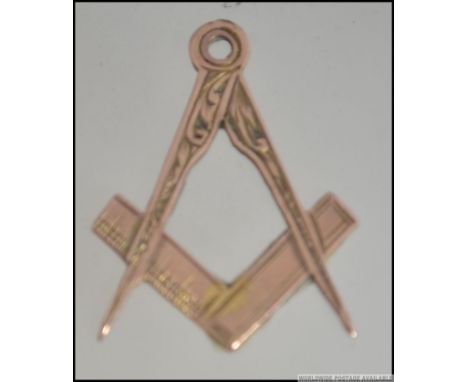 A 9ct gold hallmarked Masonic symbol necklace pendant in the form of a compass and rule. Hallmarked for Birmingham 1908, make