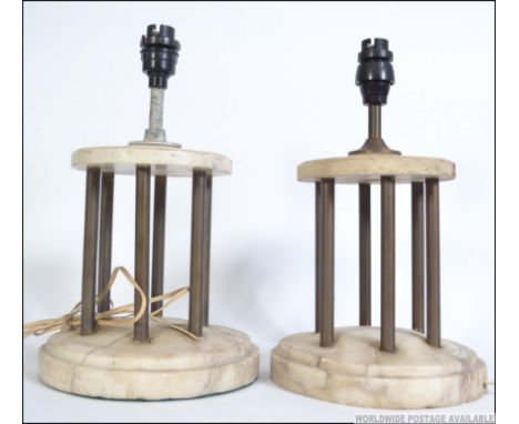 A pair of marble early 20th century portico table lamps with copper column supports to upper wooden tiers with lamp fitments.