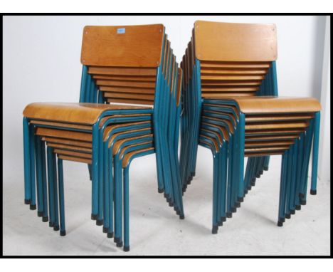 A set of fifteen vintage industrial mid 20th century church / village hall stacking chairs. having a stunning teal painted tu