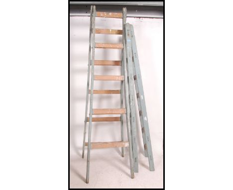 A pair off vintage mid century vintage wooden builders trestle stands with metal clasp to the top, painted frames. Measures 2