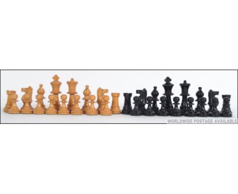 An early 20th century weighted club chess set, likely ebony and box wood. Complete in the original wooden case. Kings measure