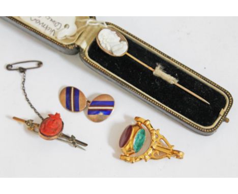 A mixed lot comprising a Victorian coral cameo brooch marked '9ct', a pair of cufflinks marked '9ct', a yellow metal swivel f