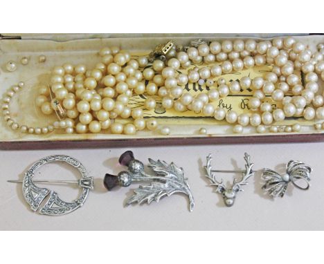 A mixed lot comprising a Celtic style hallmarked silver plaid brooch, a Scottish brooch formed as thistles with amethyst colo
