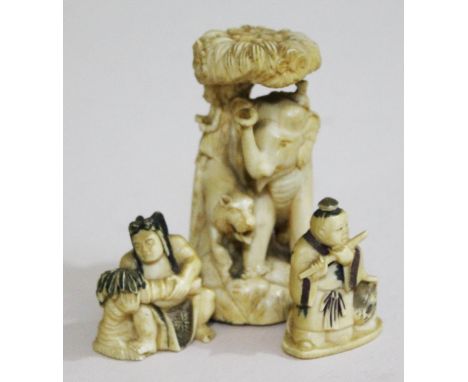 Two Japanese carved ivory netsukes and a carved ivory figure depicting a tiger and an elephant, early 20th Century.