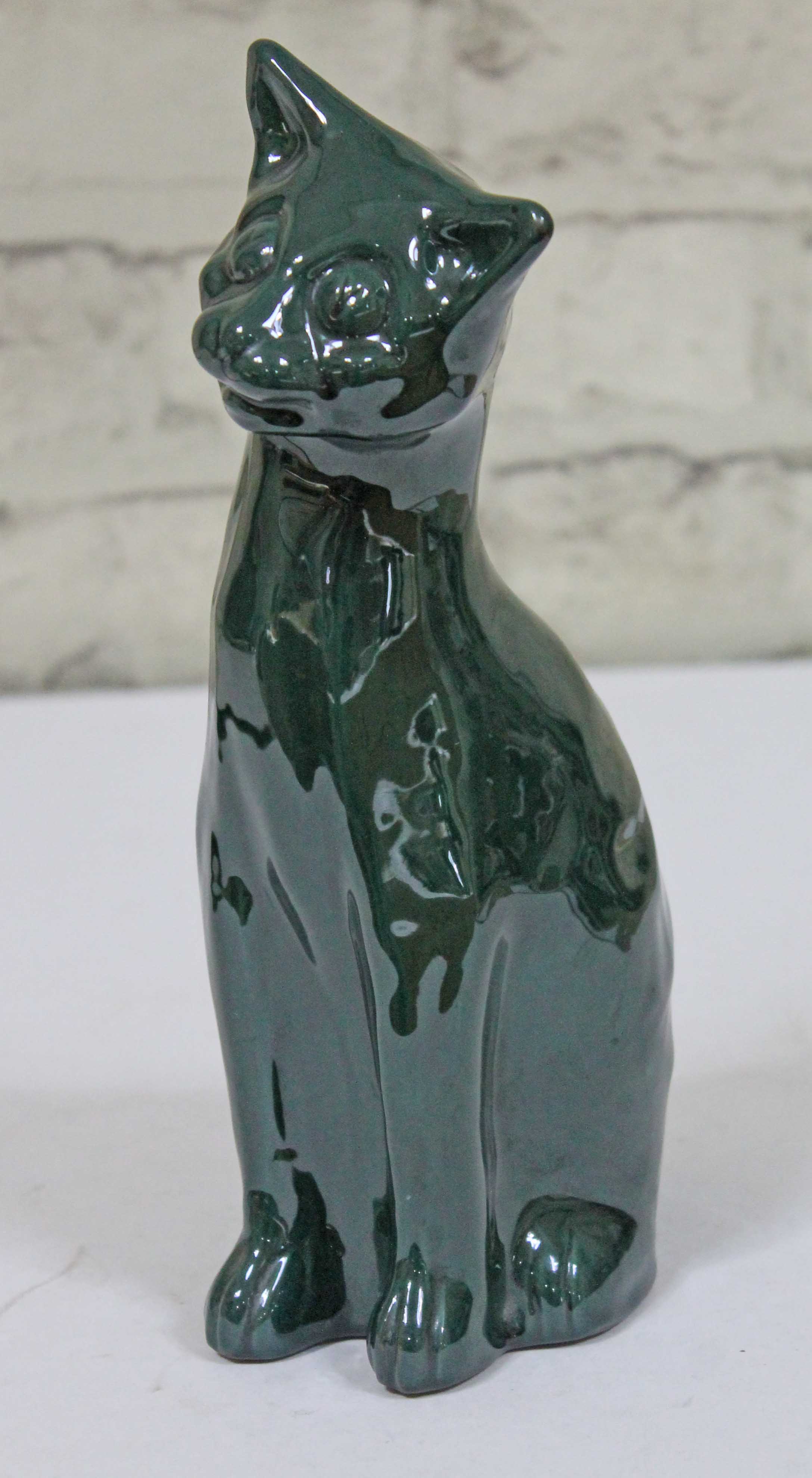 An Arts & Crafts pottery cat with green glaze by C H Brannam Barum