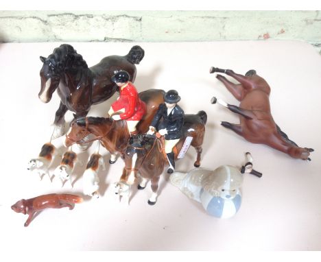 A Beswick hunting set comprising two horse and riders, four dogs and a fox, together with two other Beswick horses and a Span