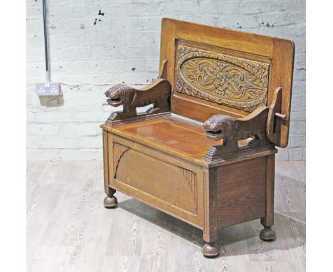 An oak monks bench circa 1920, width 106.5cm, depth 51cm & height 67cm.