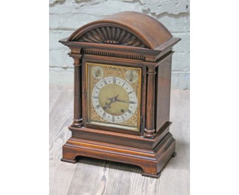 A domed top mantel clock with brass and steel dial, height 45cm.