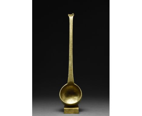 Ca. 1100-1200 AD. A brass ladle with a deep, round bowl featuring high sides that ensure a generous capacity, ideal for servi