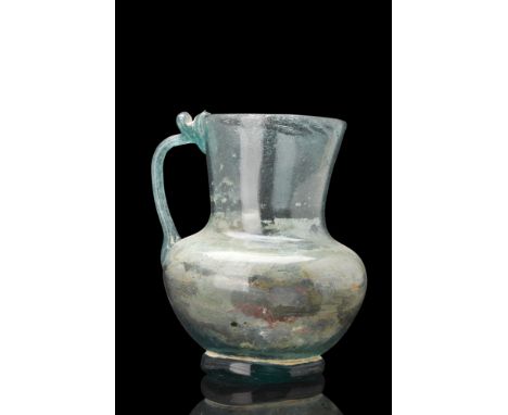 Ca. 300 AD. A glass jug that exudes an aura of ethereal beauty. Its exquisite light blue hue creates a mesmerizing play of li